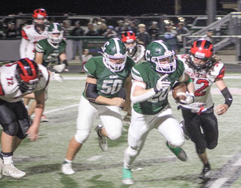 Beaverton’s Angel Cerda closes in on Clare ballcarrier Mason Heintz during the Pioneers 54-0 victory Friday night in a Jack Pine conference crossover. The win locked up a playoff berth for Clare with a 6-4 record.