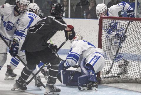 Gladwin goalie Preston Willert fights off the traffic in front of the net to make another save during Saturday night’s season-opening loss to visiting Jackson United.