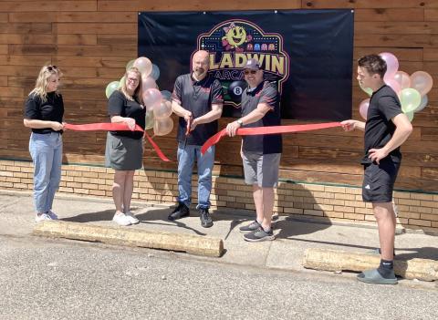 The new Gladwin Arcade on N. Silverleaf was officially opened during a ceremony Friday. Helping with the ribbon cutting were (left to right) Samantha Fessenden, Karyn Fessenden, Ryan Fessenden, Chris Dickens and Collin Fessenden.