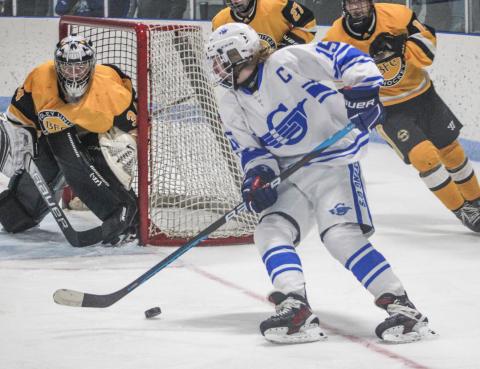 Gladwin’s Treyton Siegert goes to the backhand to cut in on the Madison Heights Bishop Foley goalie during Saturday’s victory over the visiting Ventures.