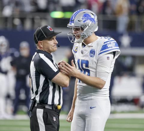 Detroit Lions quarterback Jared Goff (16) talks with umpire Duane Heydt after a 2-point conversion play by the Lions against the Dallas Cowboys in the second half of an NFL football game, Saturday, Dec. 30, 2023, in Arlington, Texas. The Cowboys won 20-19. AP PHOTO/MICHAEL AINSWORTH