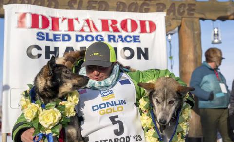 Ryan Redington poses with his lead dogs Sven, left, and Ghost, after he won the 2023 Iditarod Trail Sled Dog Race, Tuesday, March 14, 2023 in Nome, Alaska. Redington, 40, is the grandson of Joe Redington Sr., who helped co-found the arduous race across Alaska that was first held in 1973 and is known as the “Father of the Iditarod.” (Loren Holmes/Anchorage Daily News via AP)