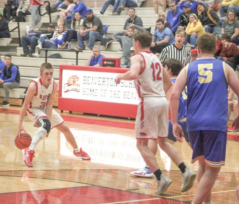 Beaverton’s Layk Woodruff goes between the legs with the dribble as he looks for an open teammate during the Beavers victory over Coleman Friday night.