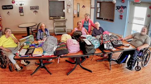 Residents at Gladwin Nursing and Rehabilitation Community show school supplies collected during their Back-to-School Drive.