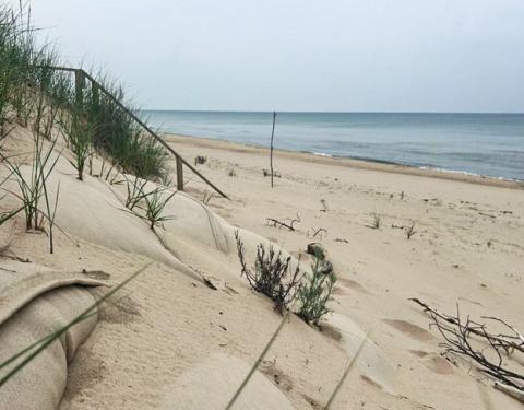 Half-buried sandbags line the front of a property in Lake Charter Township in Southwest Michigan. The water has dropped to below-average levels, but many residents are keeping their defenses in place for the inevitable rise. EMILIO PEREZ IBARGUEN