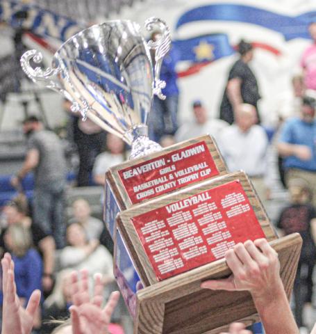 The Cedar Cup is hoisted toward the rafters last Wednesday night after the Gladwin volleyball team beat Beaverton.