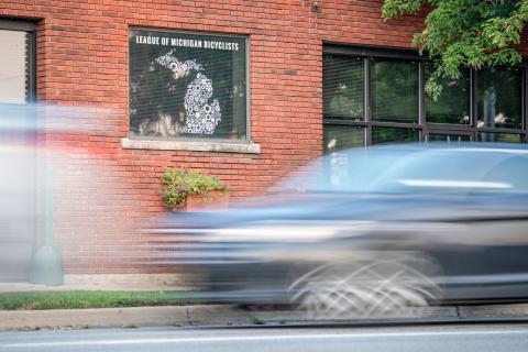 Cars pass in front of the League of Michigan Bicyclists office in Lansing. DONTÉ SMITH
