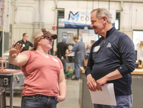Mid Michigan College President Tim Hood converses with Mariah Huguelet.