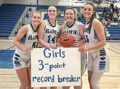 Gladwin seniors (left to right) Breanna Campbell, Abby Robinson, Sofia Sorensen and Ava Gary gather on Senior Night to celebrate Robinson’s new school record for 3-pointers in a season.