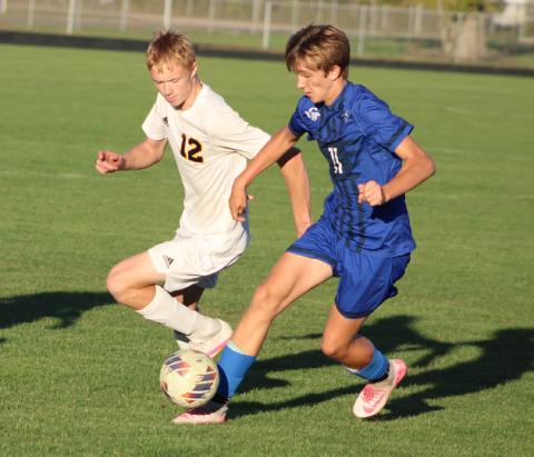 Gladwin’s Keaton Mausolf battles an Ithaca defender for the ball during Thursday’s hard-fought 2-1 loss.