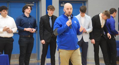Coach Marc Jarstfer gives inspiring speech during the ring ceremony for the Gladwin Flying G’s 2022 varsity football team, praising two communities coming together as one for something special.
