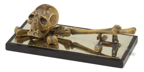 This paper clip features a bronze skull and bones, making it ready for Halloween any time of the year. Is it a modern-day memento mori or a comment on the tedium of paperwork? KOVELS.COM