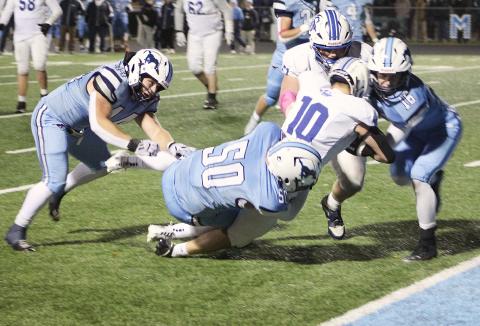 Jason Pahl is hit at the 1-yard line before falling into the end zone for a touchdown during the second half of Gladwin’s 28-13 loss at Meridian Friday night.