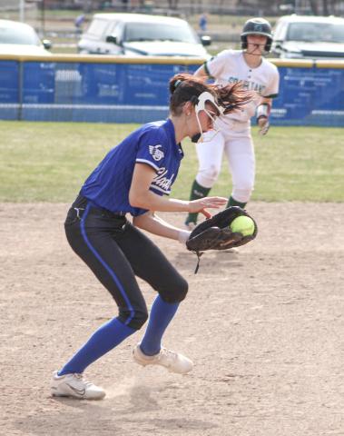 Austin McCormack digs up a ground ball at third base for the Gladwin softball team during a game earlier this season.