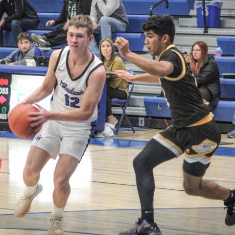 Gladwin’s Jacob Pahl looks inside for an open teammate during Thursday night’s impressive victory over visiting Ogemaw Heights.
