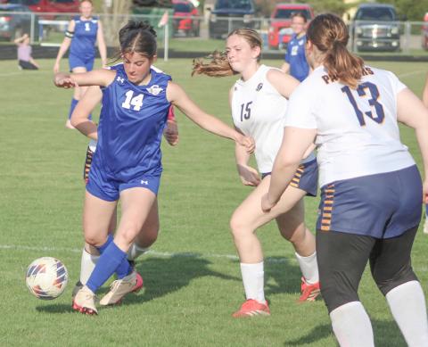 Gladwin’s Macy Spitnale battles three Standish defenders for control of the ball during Thursday’s loss to the visiting Panthers. GLADWIN