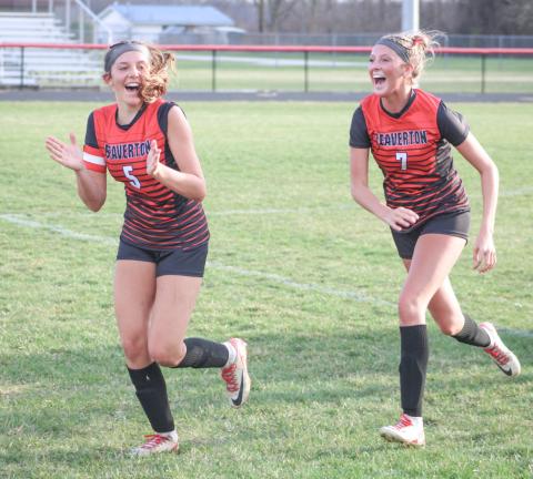 Piper Carland and Braylin Orton run off the field joyously after the Beaverton soccer team beat rival Gladwin 4-1 last week.
