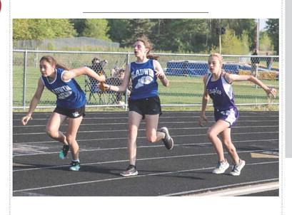 Ruby Vannest hands off to Elizabeth Huisjen during the Conference Championship’s relay race. PHOTO PROVIDED BY ANN MANNING