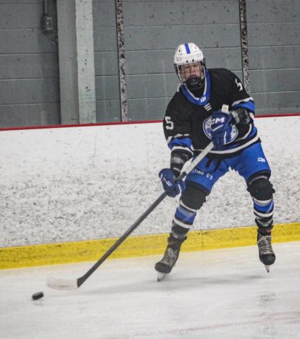 Gladwin’s Caden McKeever sends a pass toward the front of the net during a recent game.