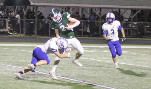 Gladwin’s Brayden Schroeder brings down Clare’s Conan Weeks with a nice open field tackle during Friday night’s 28-26 victory, the first of the season for the Flying G’s.