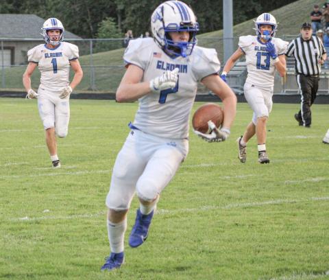Gladwin wide receiver Bronson Bigham heads for the open field during a game at Ogemaw Heights last season.