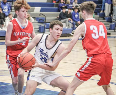 Gladwin’s Brody Verellen battles in the paint during last Tuesday night’s victory over Beaverton in the Battle For Butch.