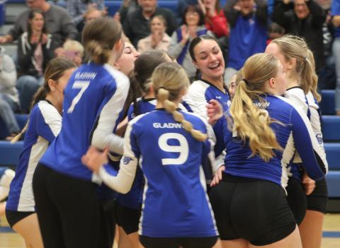 Gladwin’s volleyball team whoops it up after knocking off Clare in the district semifinals last Wedensday night.