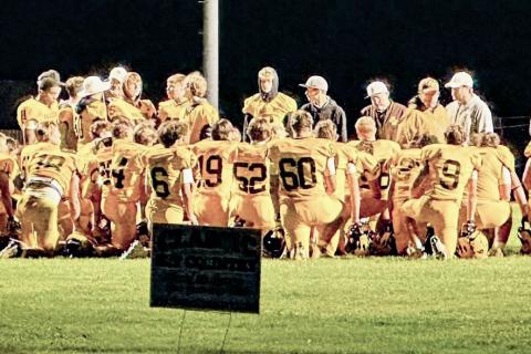 The Ogemaw Heights football team hears words of encouragement after Friday night’s loss to Traverse City St. Francis.