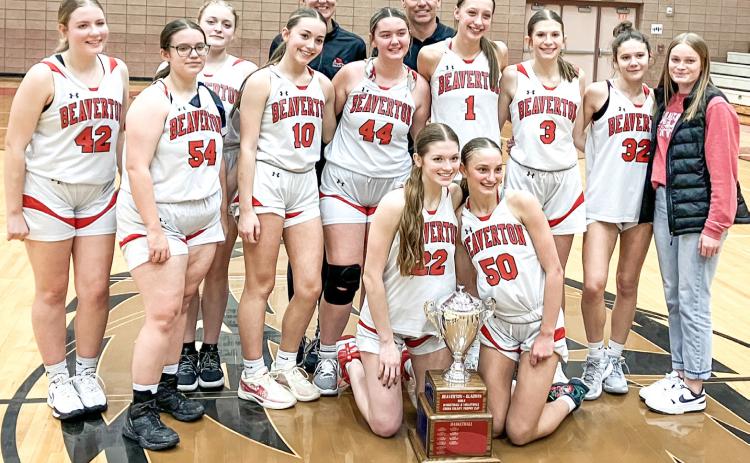 The Beaverton girls’ basketball players and coaches posed with the hardware after beating rival Gladwin for the Cedar Cup last Wednesday.
