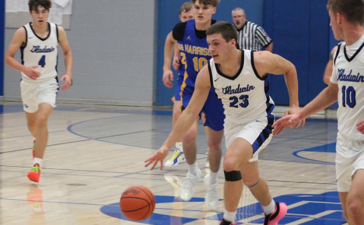 Colton Pfenninger runs the floor during Gladwin’s 67-47 victory over Harrison in the home opener on Friday night.