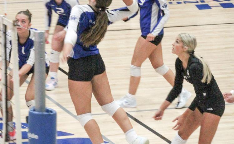 Gladwin’s big hitter Ansley Mausolf gets up and at ‘em during last Wednesday night’s impressive threeset victory over Ogemaw Heights.