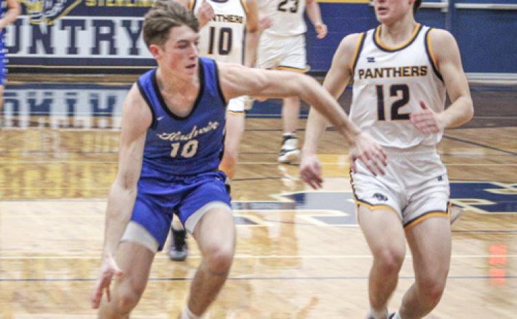 Gladwin’s Seth Mead tries to force his way to the basket during Friday night’s district final loss at Standish.