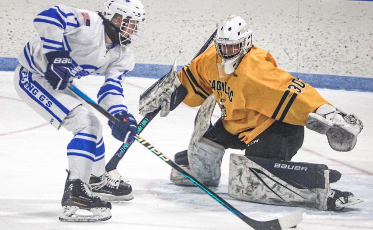 Gladwin’s Braeden Guzman slips a back-hander into the net during Saturday’s 6-3 victory over Cadillac.