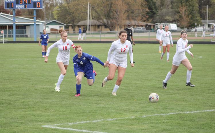 Gladwin’s Isabella Roman chases the ball toward the Beaverton net with Charity Danielak, Isabelle Dodman and Blaire Orton in hot pursuit during Wednesday’s game.