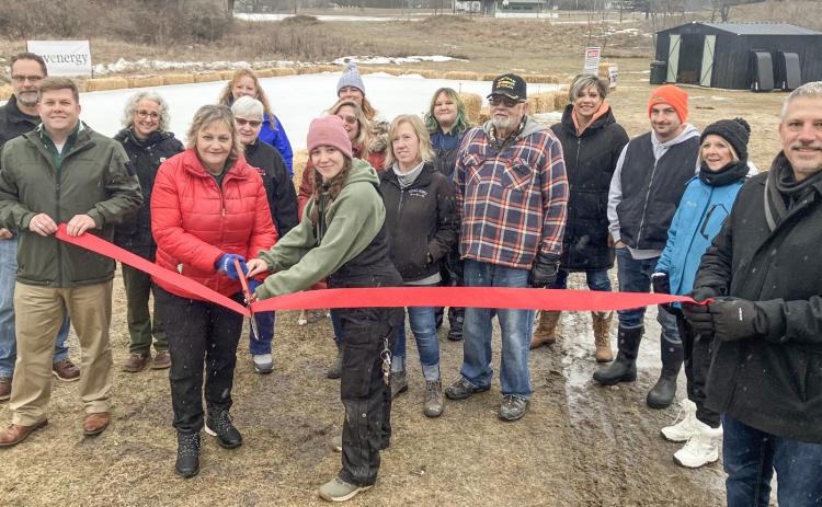 Gladwin Interim City Administrator Kimberly Hines and City Park Manager Sabrina Battjes handle the big scissors Saturday at a ribbon cutting to open the new North Park Winter Wonderland.