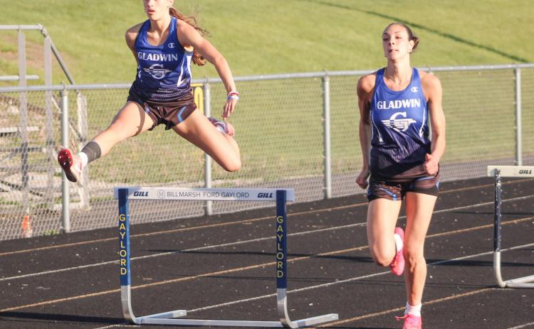 Gladwin’s Bree Visser takes flight as two-time All-State teammate Ava Gary picks up steam during the 300 hurdles at the Northern Michigan Meet of Champions last Tuesday.