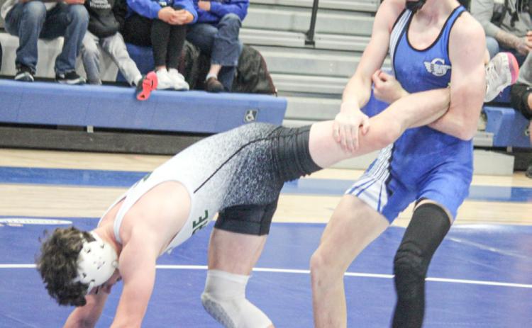 Gladwin’s Ethan Palmateer locks up a leg during Thursday’s team district tournament. Palmateer went on to win an individual district championship Saturday.