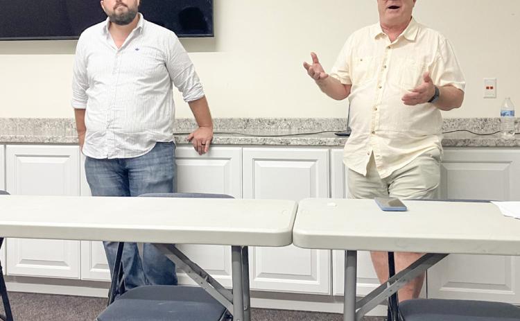 Environmental advocates Sean McBrearty (left) and David Holtz address a crowd of citizens Monday evening at the Gladwin County District Library, detailing their opposition to the proposed construction of an oil tunnel beneath the Straits of Mackinac.