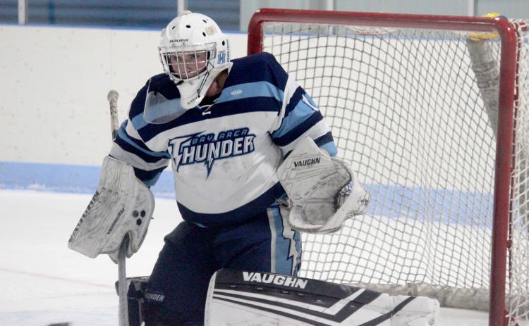 Trenton Reid defends the net against Bishop-Foley.