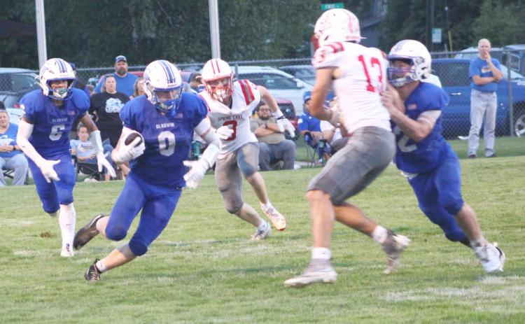 Gladwin’s Bronson Bigham looks for running room during Gladwin’s loss to Spring Lake Thursday night.