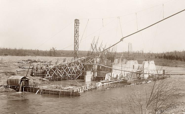 Pictured is Edenville Dam construction in 1924. Upon completion, it would retain a summer-time pond at 675.8 feet, creating Wixom Lake in the river valley of the Tittabawassee and Tobacco rivers. The dam held for 95 years – the failure was of the embankment that catastrophically collapsed on May 19, 2020.