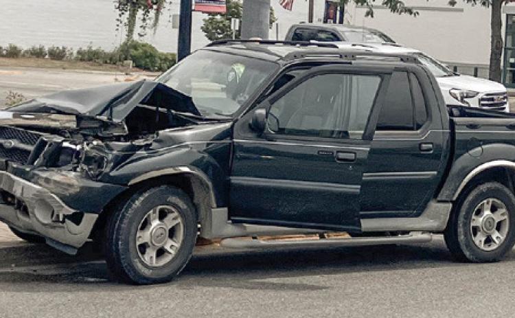 Pick-ups collide in center of town