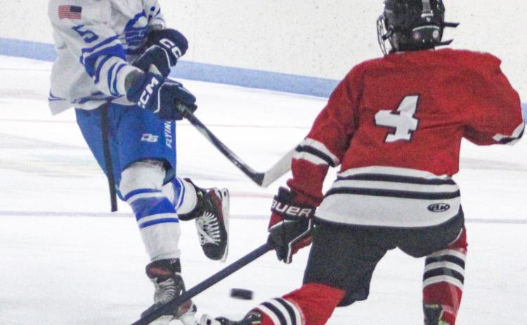 Gladwin’s Caden McKeever fires a shot past a defenseman for the FNV Griffins during the Flying G’s 4-2 victory last week.