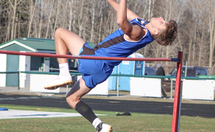 Gladwin’s Erik Roggow clears the bar in the high jump during last Wednesday’s meet at Clare.