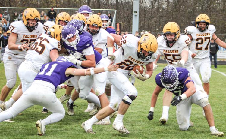 Ogemaw Heights’ Connor Lambert grinds out some tough yardage during Saturday’s victory at Saginaw Swan Valley that sent the Falcons into the Final Four in Division 5.