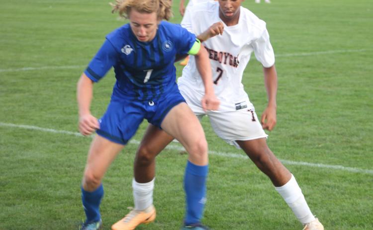 Gladwin’s Treyton Siegert battles for control of the ball during last Wednesday’s 6-2 victory over Cheboygan.