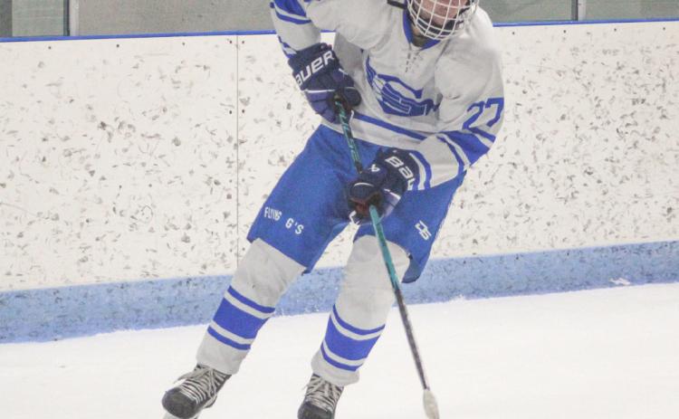 Gladwin’s Logan Shell tries to control a rolling puck as he moves toward the slot during Saturday’s loss to Petoskey.