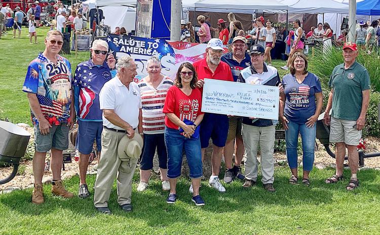 County Commissioner Mike Visnaw and County Veterans Affairs Director Ken Roberts team up to hold a big check that was donated to the Veterans Relief Fund Saturday. Also pictured: Mike Fitch, first tee shooter and George Alward, Chairman of the Gladwin County Veterans Council. Also, Sugar Springs Board of Directors Jeff Weeman, Craig Taunt, June Jucewicz, Sherri Visnaw, Tom Hug, and Eve Kaltz.