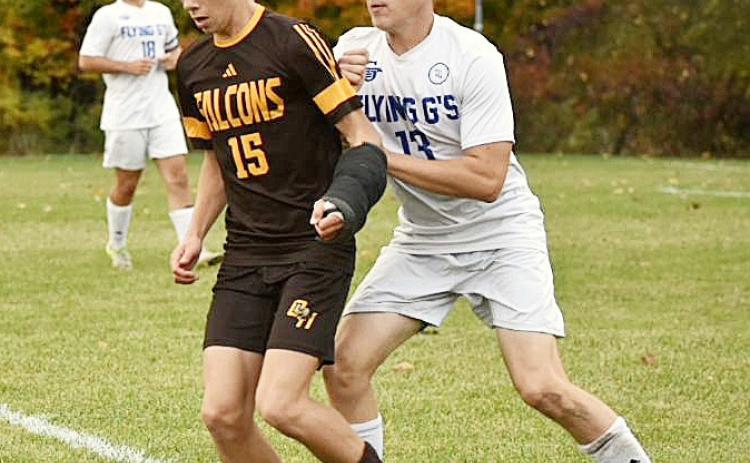 Gladwin’s Luken Binger applies defensive pressure during last Wednesday’s district tournament win at Ogemaw Heights. PHOTOS BY BETH ORR
