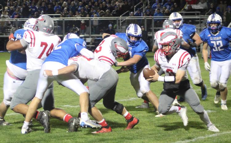 Gladwin’s defense tries to corral Frankenmuth quarterback Jack Rich during Friday night’s loss in the regular season finale.